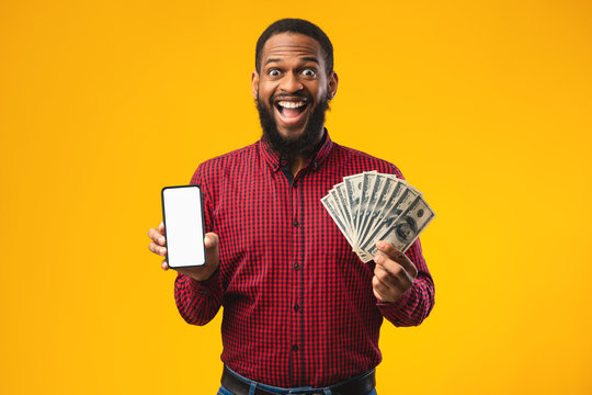 Afro guy holding mobile phone and bunch of money