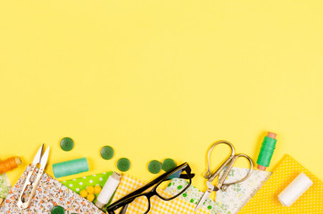 Sewing set with fabric, spools of thread, scissors and glasses