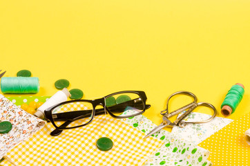 Sewing set with fabric, spools of thread, scissors and glasses