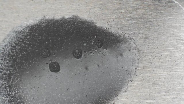 Acid etching metal in an industrial process