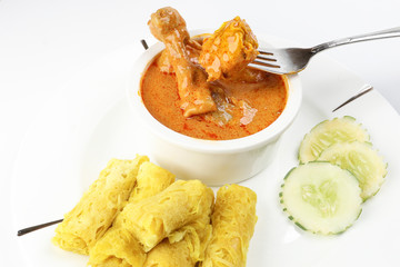Traditional Malay snack food Roti Jala served with curry chicken with potato on white ceramic plate and bowl