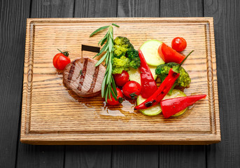 Grilled bbq steak with potato cube and tomatoes.