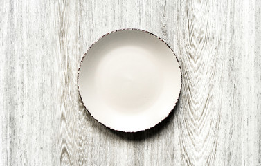 Plate on a wooden background close-up. 