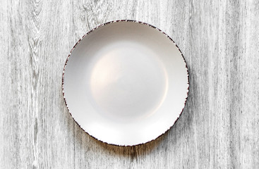 Plate on a wooden background close-up. 