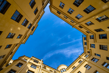 Courtyards of wells in St. Petersburg, a view from below of the blue sky.