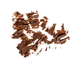 Chocolate broken pieces and shavings isolated on white background. Chunks of dark chocolate...