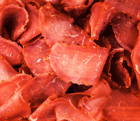 Smoked beef meat slices background, basturma, biltong, jamon