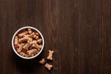 Dog food. Dry food on a wooden background. Copy space.