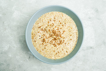 Healthy breakfast on a light background with place for text. 
Flaxseed porridge.