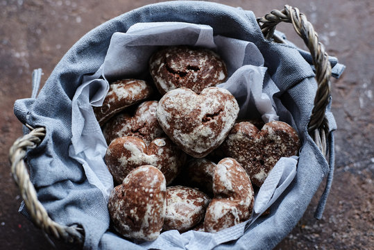 small heart-shaped chocolate gingerbread cookies in a gray basket - Powered by Adobe