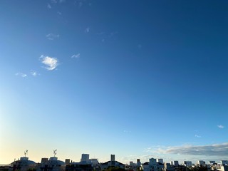 Blue background. Clouds. City. Nature and the City.   