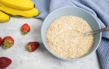 Flax porridge with banana and strawberries on a light background. Healthy breakfast
