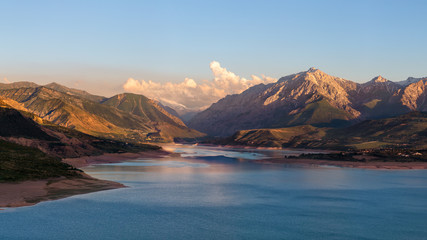 Obraz na płótnie Canvas Beautiful mountain lake. Amazing mountain landscape with lake and sunset. Uzbekistan, Charvak Lake, 2020
