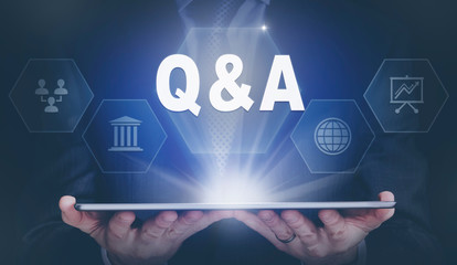Businessman holding a computer tablet display projecting a Q and A concept.