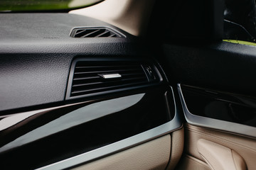 Air conditioner vent grill in a modern car.
