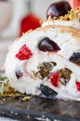 Meringue roll with fresh berries and cream cheese