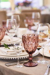 A glass of dark glass stands in the foreground.