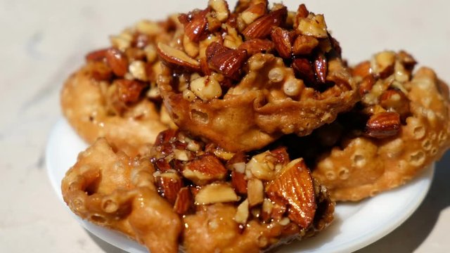 Cartellate Pugliesei italian traditional food from Puglia region named crispy puff pastry with honey and almond