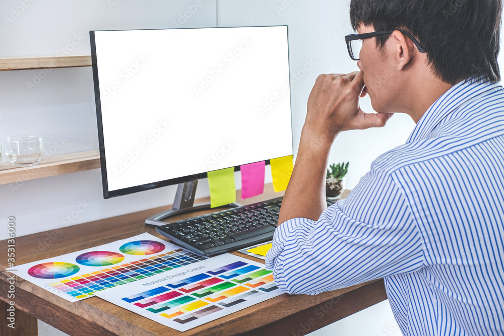 Aufkleber Image of male creative graphic designer working on color selection and drawing on graphics tablet at workplace with work tools and accessories in workspace