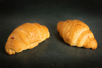 fresh croissants on dark surface