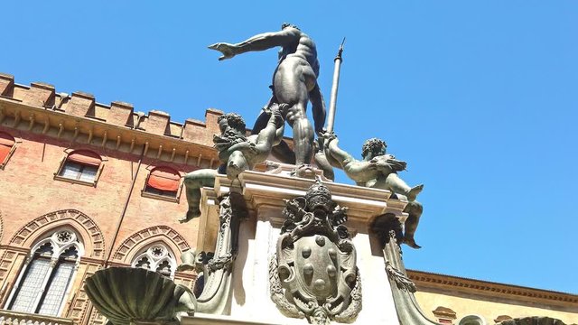 HYPER-LAPSE LOOP: Nettuno 1567 bronze statue fountain in front of Accursio palace, built in 1290, in Piazza Maggiore square, the seat of the municipal government of Bologna