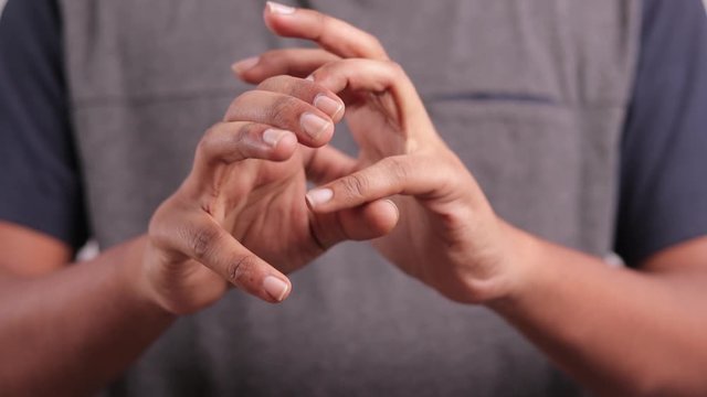 Man cracking finger knuckles or joints - Concept of a sense of relief or relaxation from tension.