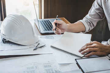 Construction and structure concept of engineer or architect working on blueprint, Engineer working with engineering tools for architectural project on workplace, building project, blueprints