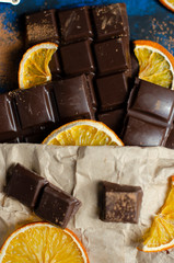 pieces of dark chocolate in a paper bag with dried oranges
