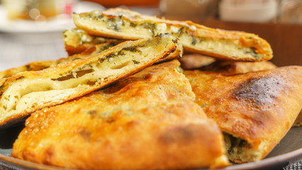 Two Georgian pies. One with cheese, the other with spinach. Traditional Georgian dish khachapuri.