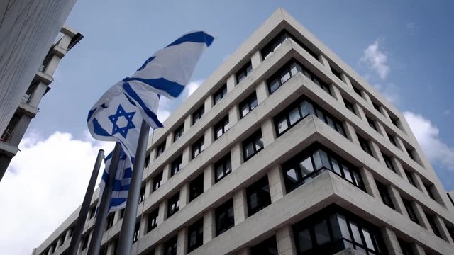 State Flag of Israel. The Big Flag flutter epically in the wind against the bricks wall. National simbol. Jerusalem