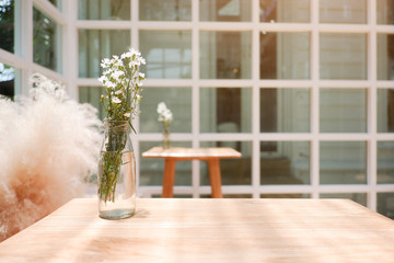 Fototapeta premium Natural ordinary view and objects for background. Flower in the jar set on the wood table.