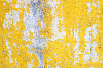 Concrete yellow colorful wall surface texture. Abstract grunge bright color background with aging effect. Copyspace.