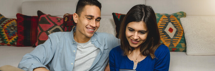 Close up smiling young couple at home calculate family budget. Savings, bank loan and economy...