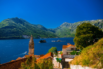 The small town of Perast is one of the most famous and visited tourist places in Montenegro. The bell tower of the Church of St. Nicholas against the background of the Bay of Kotor