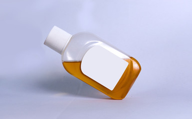 plastic bottle with orange liquid covid-19 germs killing liquid