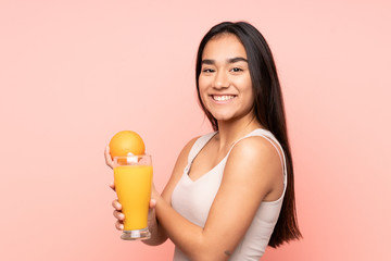 Young Indian woman holding an orange