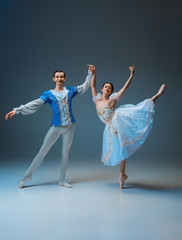 Young and graceful ballet dancers as Cindrella fairytail characters on studio background. Art,...