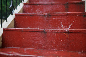Water drops splashing on wet red steps during monsoon rains in India