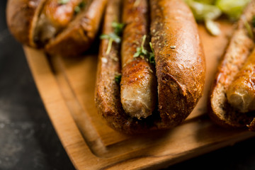 Tasty fresh hot dogs with grilled sausage on the rustic background. Selective focus. Shallow depth of field.
