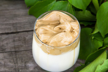 Dalgona coffee on wooden rustic background. Top view.