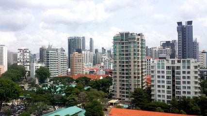 city view of singapore with condominium , HDB building and trees with background of blue sky