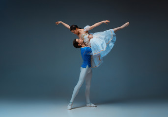 Young and graceful ballet dancers as Cindrella fairytail characters on studio background. Art, motion, action, flexibility, inspiration concept. Flexible caucasian ballet dancers posing, dancing.