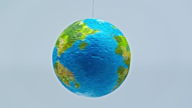 small globe spinning around isolated on grey