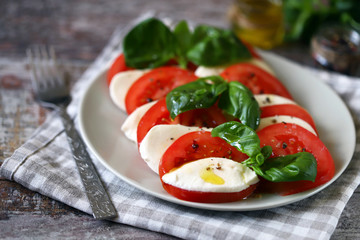 Selective focus. Italian caprese salad. Cooking at home.