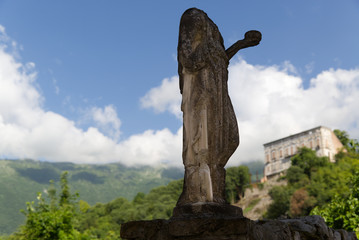 Italy, ancient statue with the castle of Polcenigo in the background