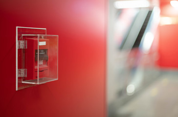 The red fire alarm switch on the wall at the Bangkok subway..