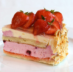 Fresh fruit cake with strawberries and sliced nuts.