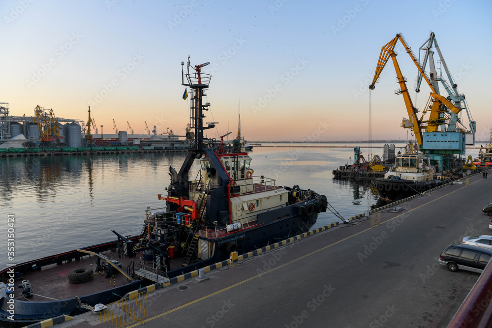 Wall mural Tugboat moored in the port of Odessa at sunset.