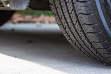 Closeup of the tread of a summer car tire on a sunny day. tires against black. fuel efficient car...