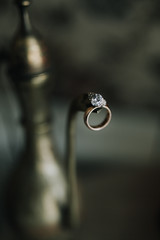 wedding ring hanging on the spout of the kettle